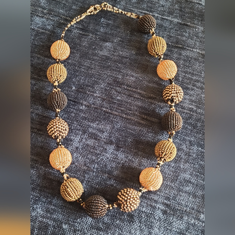 Beautiful hand beaded 21inch necklace gold,black,bronze toned beads.